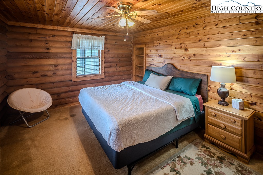 80 Avery Co High School Road Newland, NC 28657 - Photo 12 of 36 a bed room with a bed and a chair