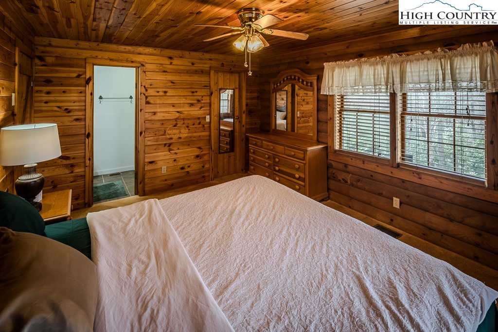 80 Avery Co High School Road Newland, NC 28657 - Photo 13 of 36 a bedroom with a bed dresser and a large window