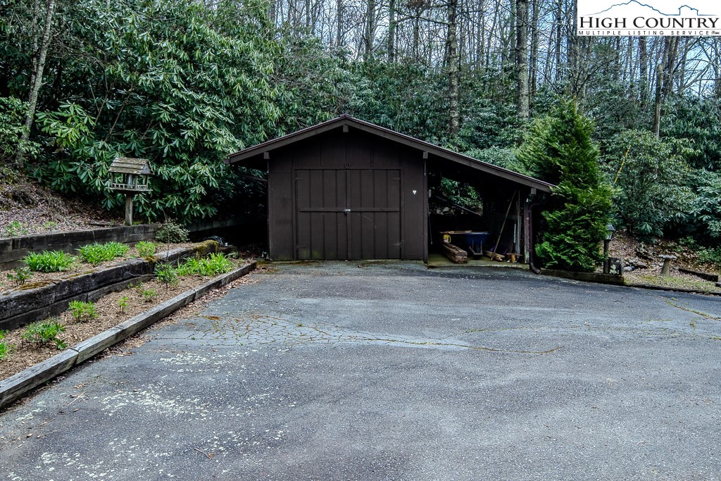 80 Avery Co High School Road Newland, NC 28657 - Photo 27 of 36 a view of a house with a yard and covered with trees