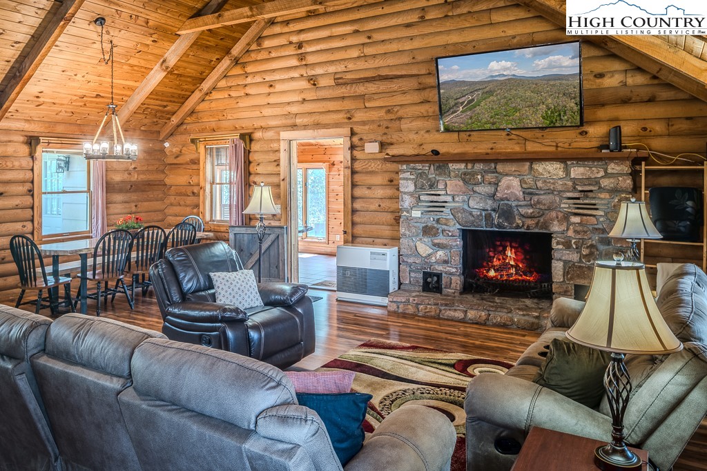 80 Avery Co High School Road Newland, NC 28657 - Photo 3 of 36 a living room with furniture a flat screen tv and a fireplace