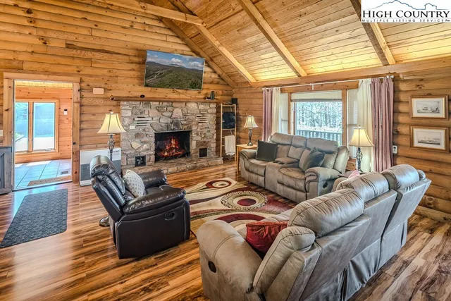 a living room with furniture a fireplace and a table