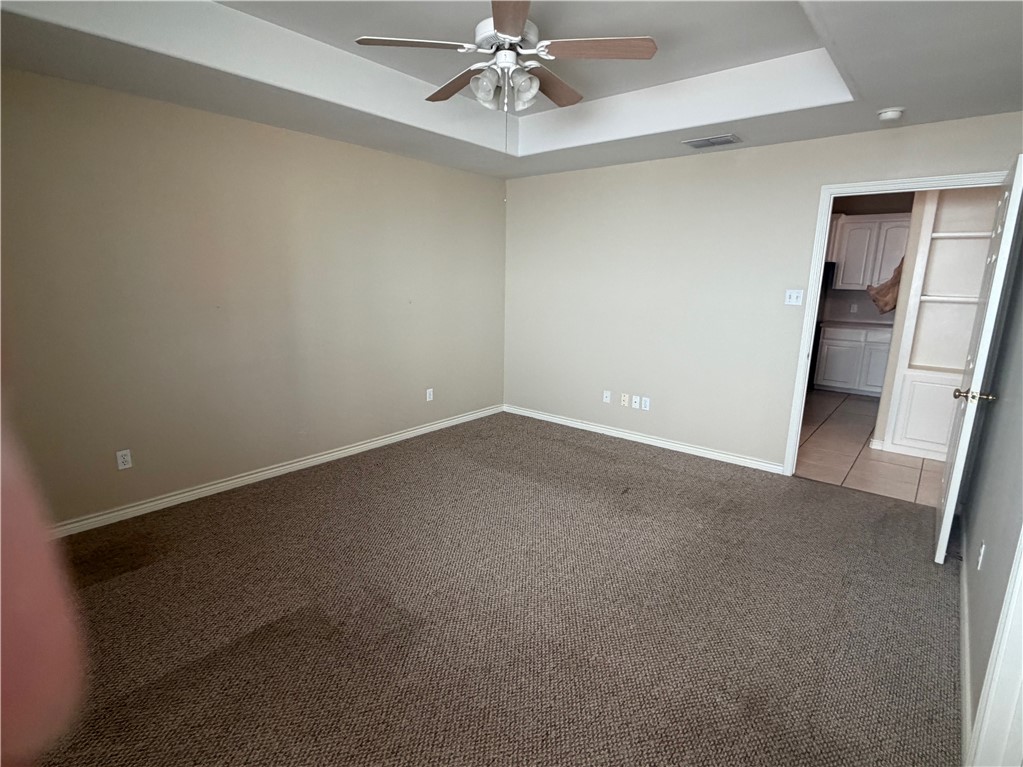 15210 Cruiser Street Corpus Christi, TX 78418 - Photo 7 of 12 en empty room with windows and ceiling fan