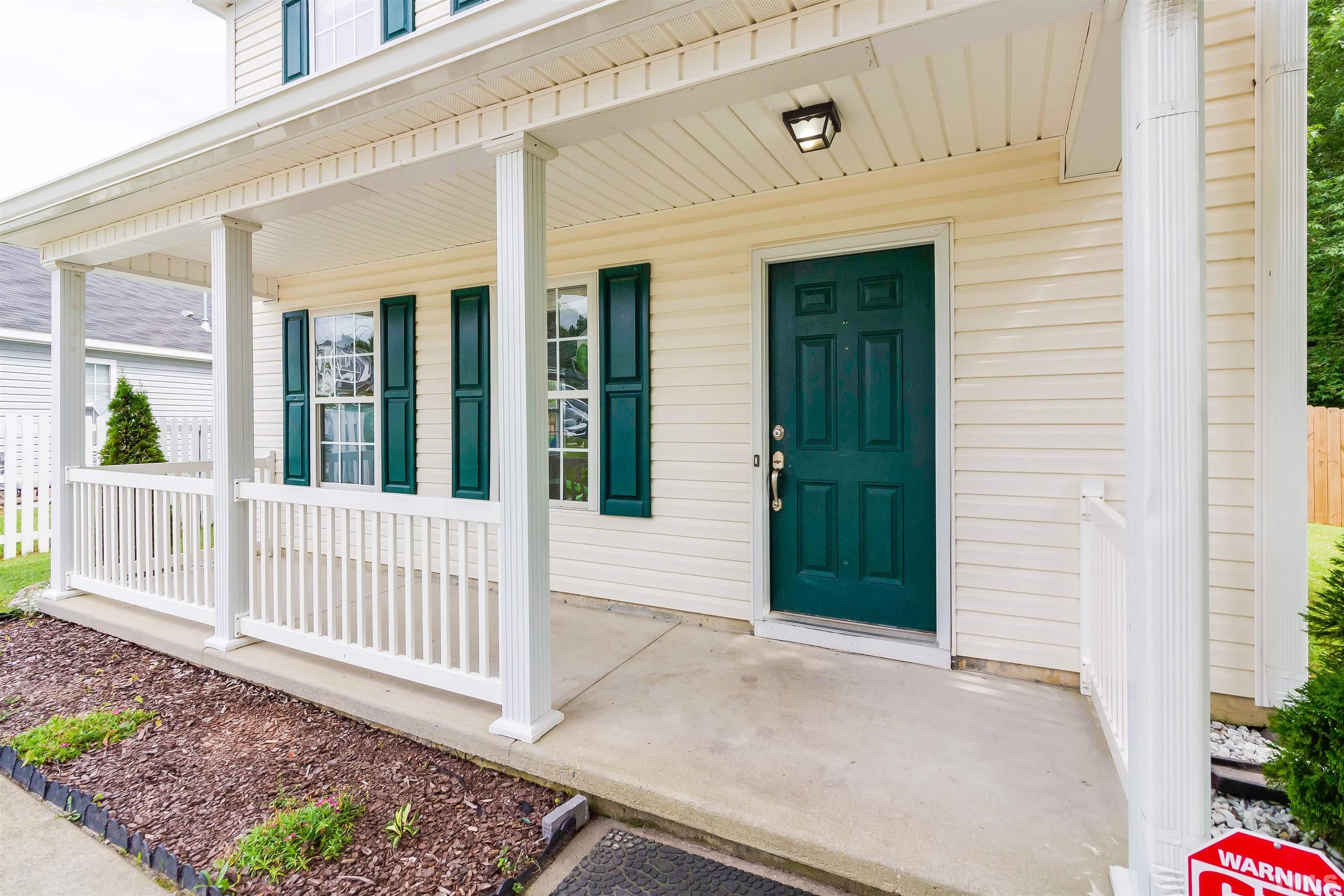 5208 Marthonna Way Raleigh, NC 27616 - Photo 4 of 17 a view of a porch with a table and chair