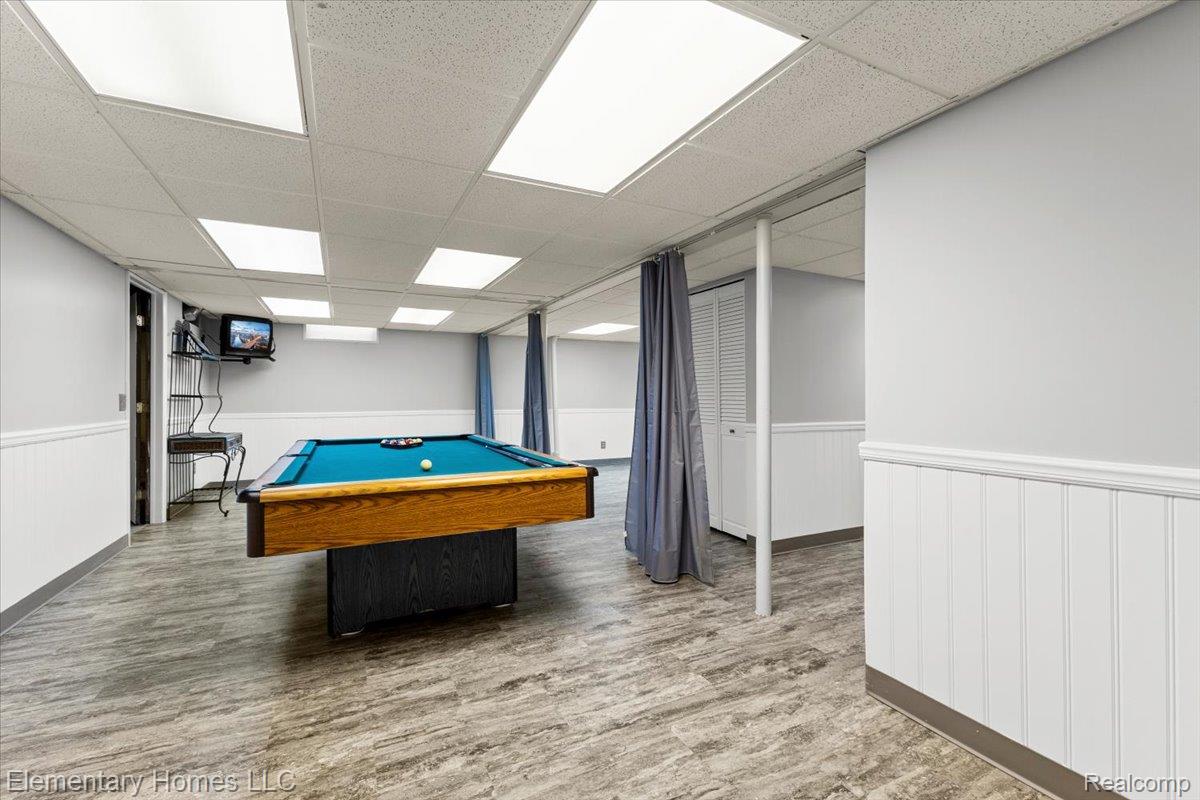 51637 Baker Road New Baltimore, MI 48047 - Photo 38 of 47 Playroom with a paneled ceiling, billiards, and a wainscoted wall
