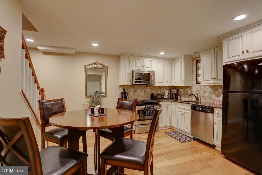 30 Pinewood Avenue Lititz, PA 17543 - Photo 37 of 73 a kitchen with refrigerator cabinets dining table and chairs