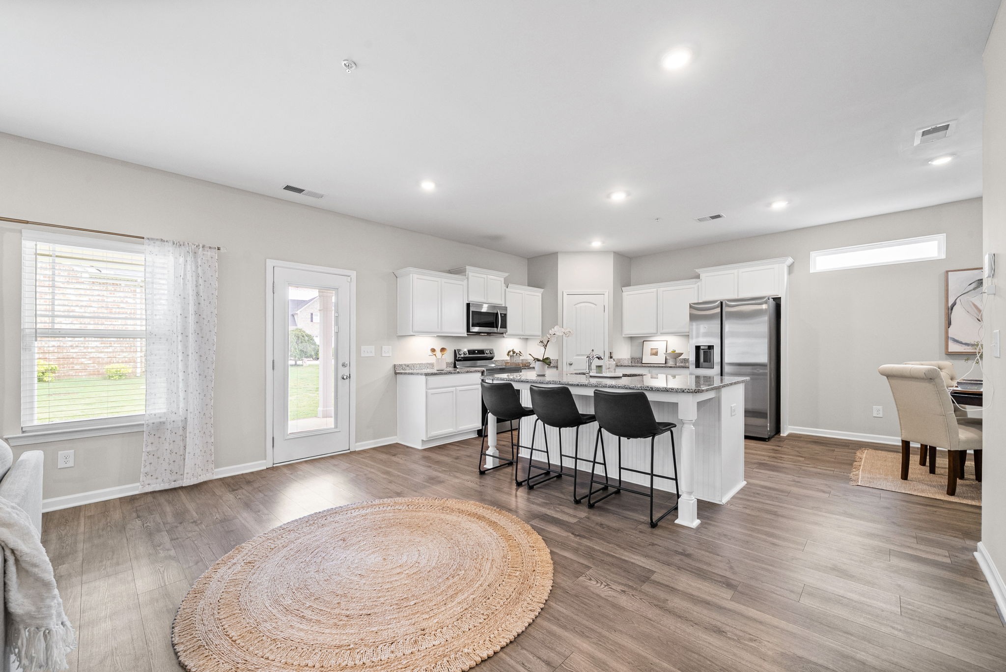 719 Reflections Lane Pleasant View, TN 37146 - Photo 12 of 46 a view of a kitchen with dining area window and wooden floor
