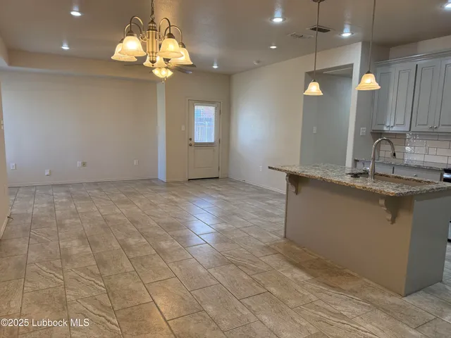 a view of a kitchen sink and a chandelier