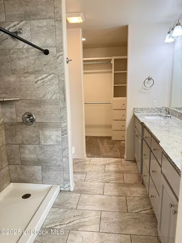 a bathroom with a bathtub and shower