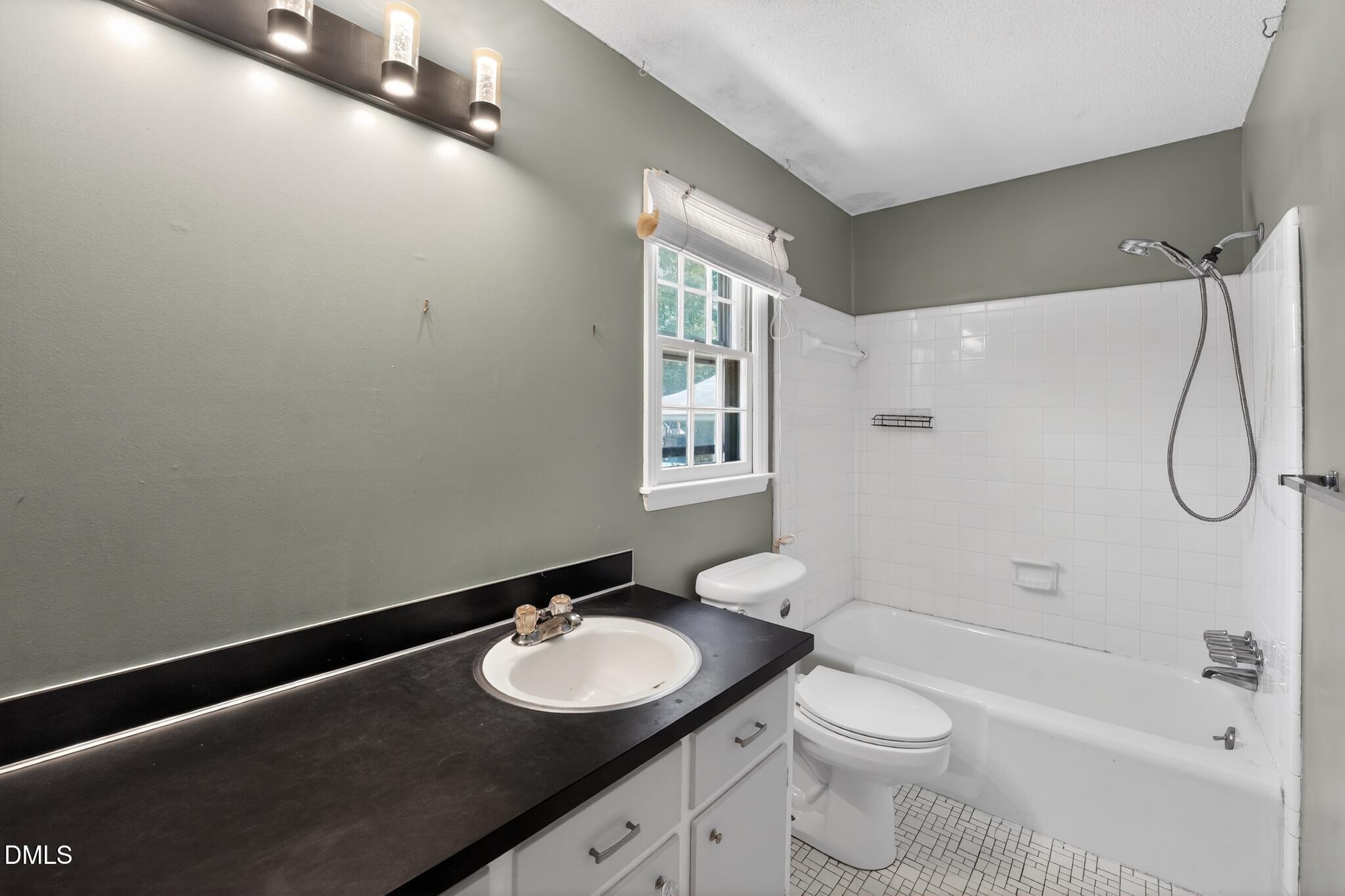 1034 Jerome Road Durham, NC 27713 - Photo 29 of 35 a bathroom with a granite countertop sink toilet and shower