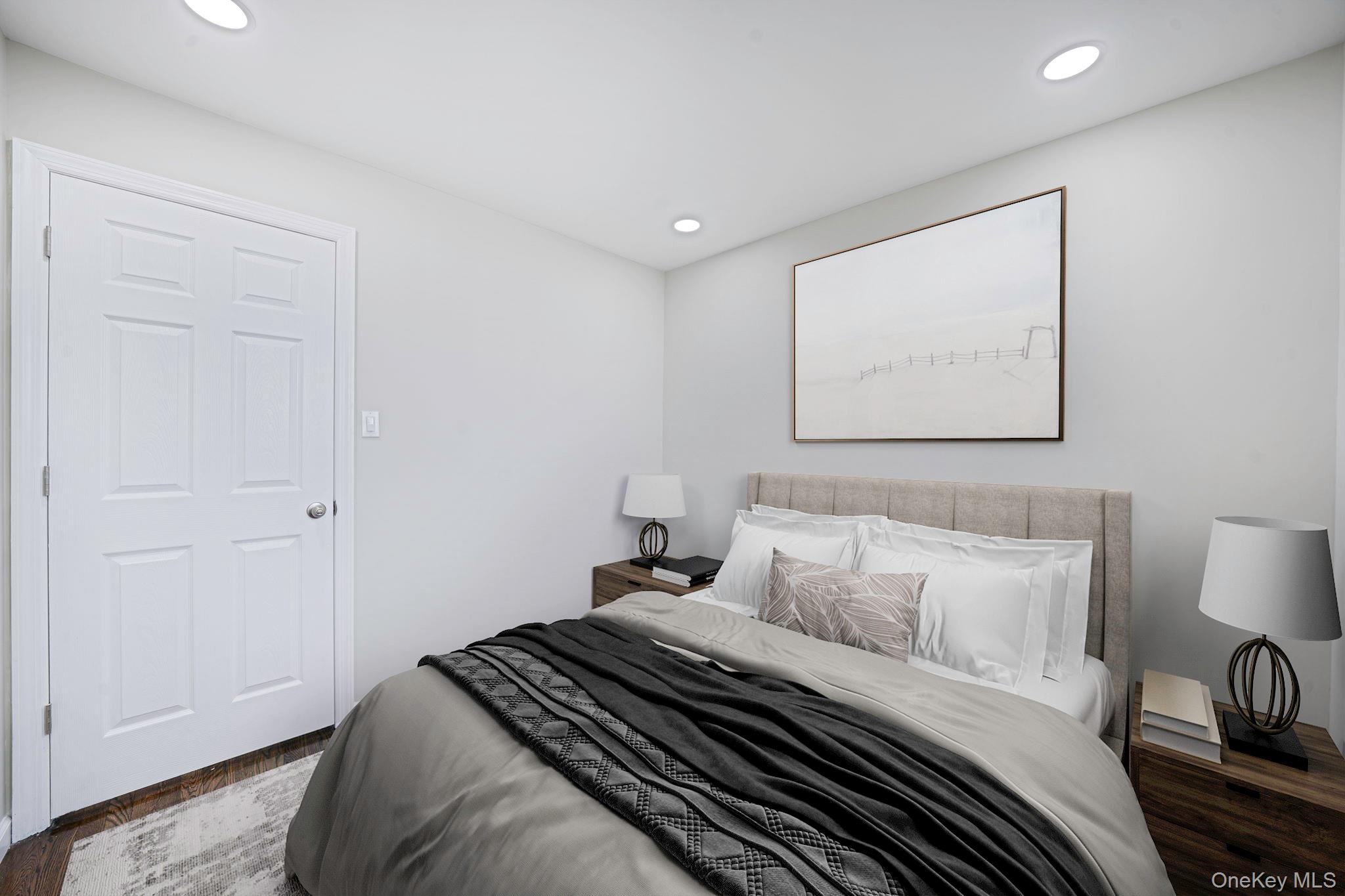 220-53 137th Road Queens, NY 11413 - Photo 15 of 41 a bedroom with a bed and a painting on the wall