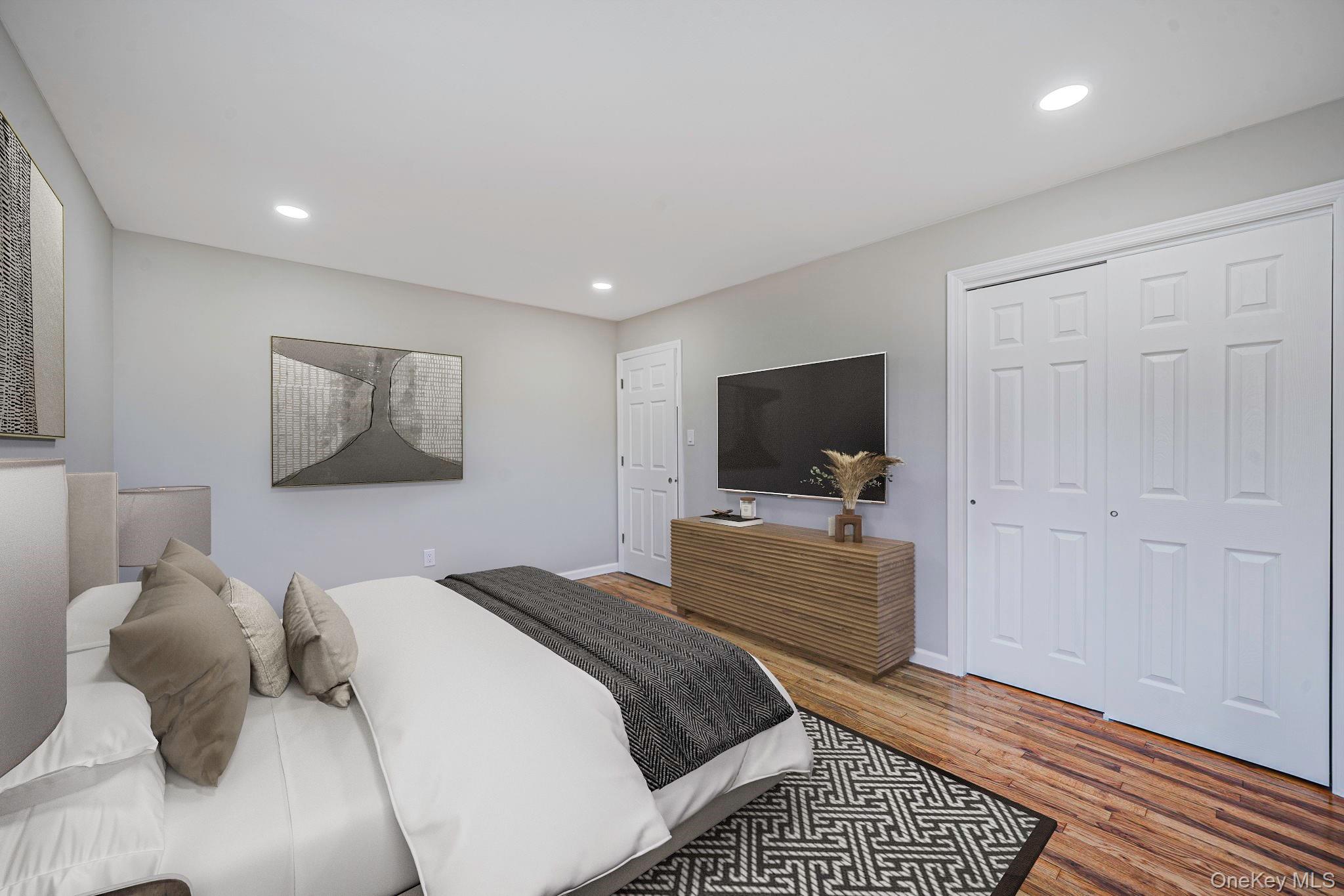 220-53 137th Road Queens, NY 11413 - Photo 22 of 41 a bedroom with a bed and a flat screen tv