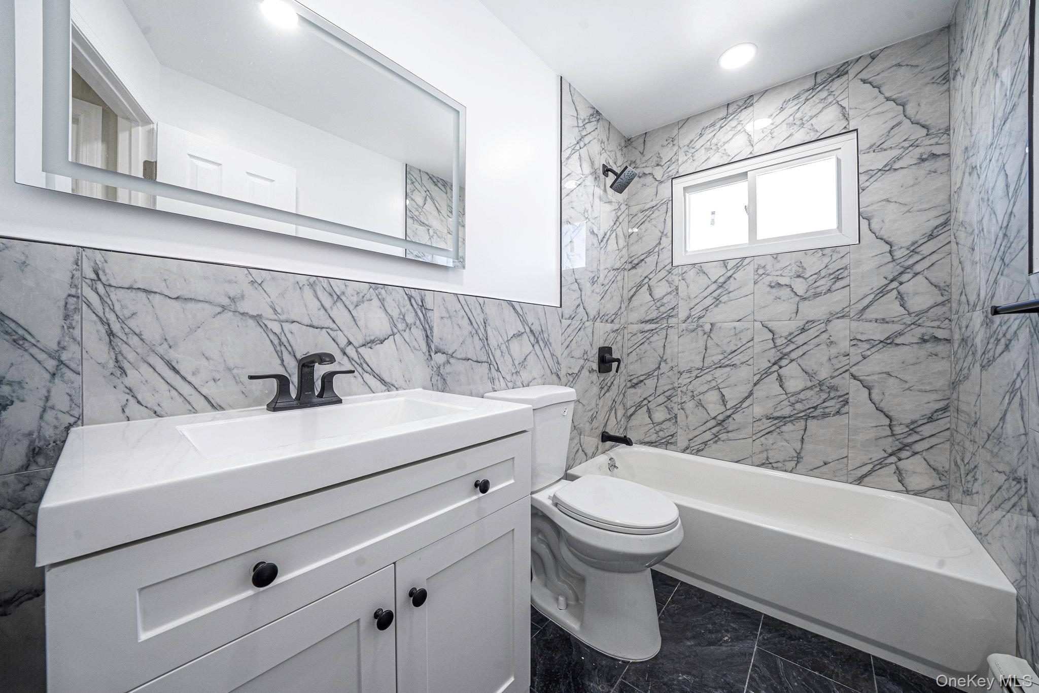220-53 137th Road Queens, NY 11413 - Photo 23 of 41 a bathroom with a sink a toilet and a bathtub