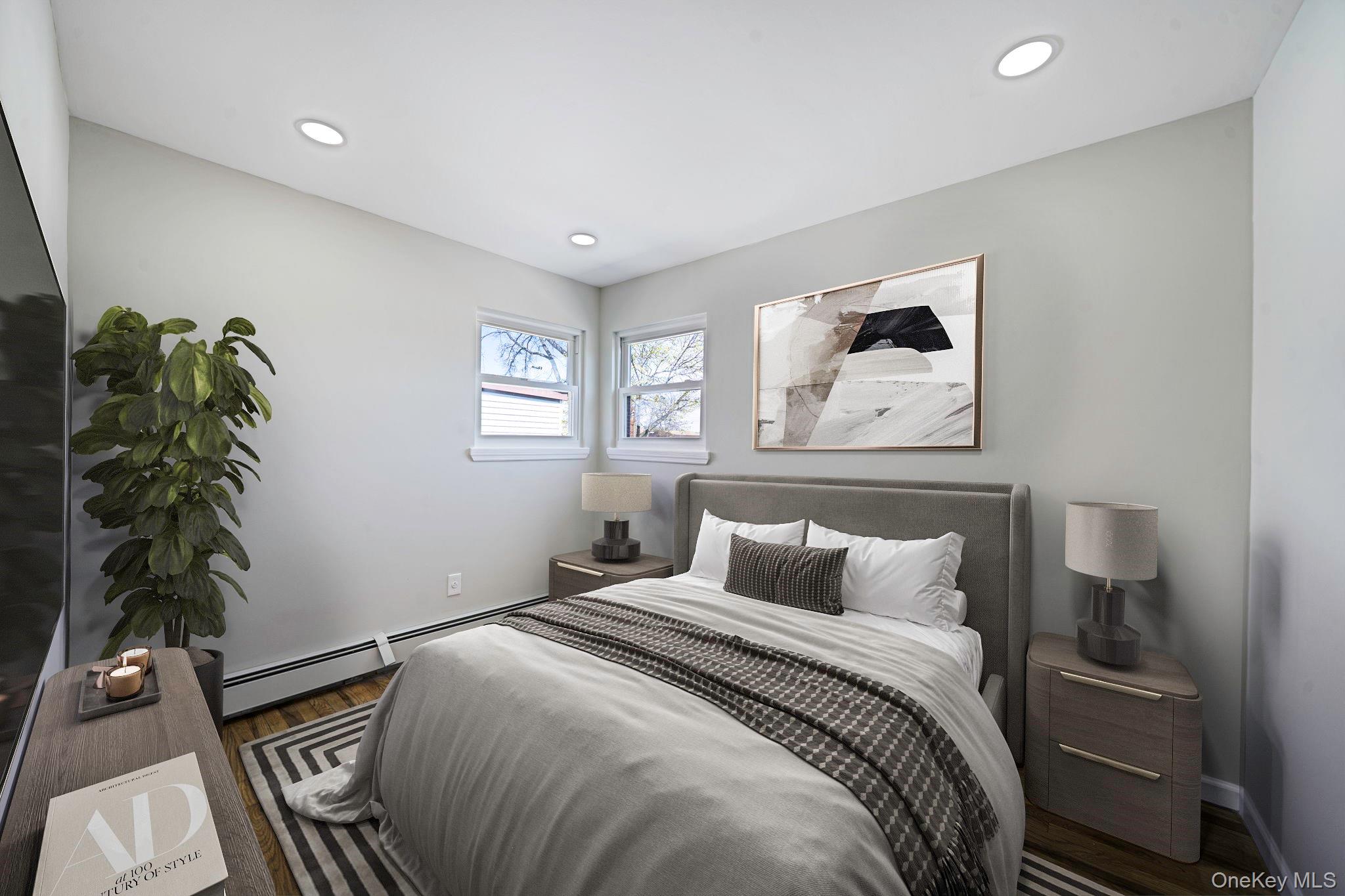 220-53 137th Road Queens, NY 11413 - Photo 24 of 41 a bedroom with a bed and a potted plant