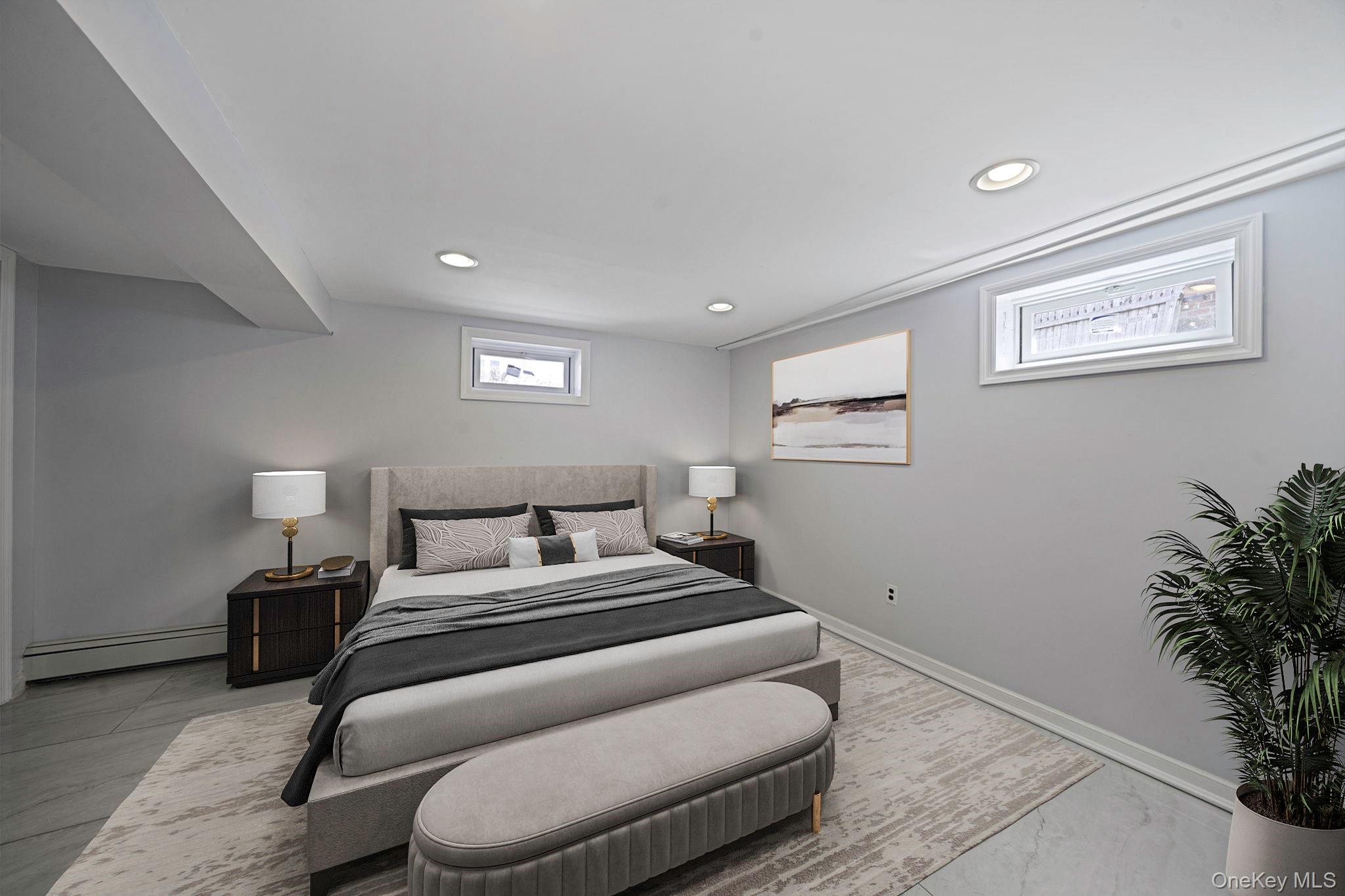 220-53 137th Road Queens, NY 11413 - Photo 32 of 41 a bedroom with a bed and a potted plant