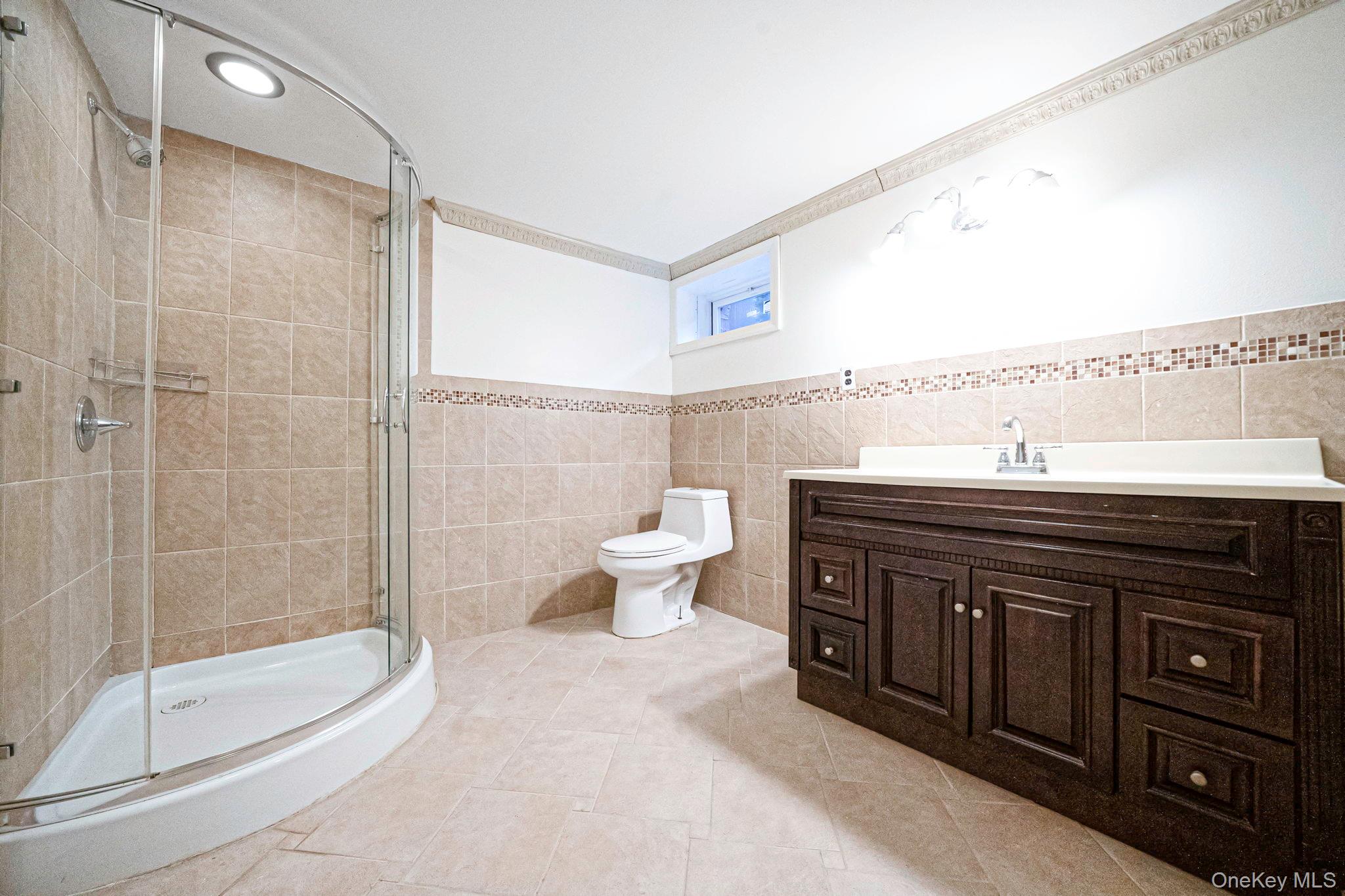 220-53 137th Road Queens, NY 11413 - Photo 34 of 41 a bathroom with a sink a toilet and shower