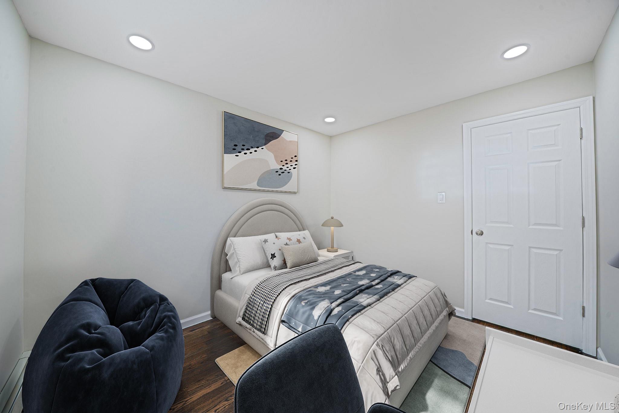 220-53 137th Road Queens, NY 11413 - Photo 9 of 41 a bed room with a bed and a couch