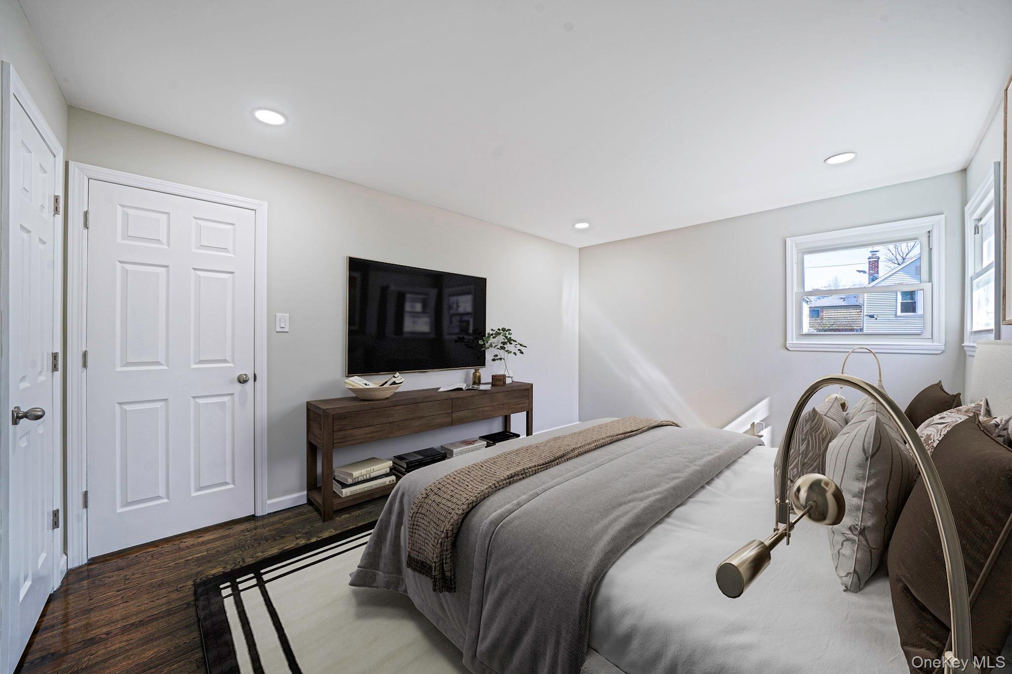 220-53 137th Road Queens, NY 11413 - Photo 10 of 41 a bedroom with a bed and a flat screen tv