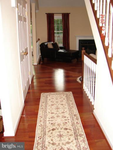 10414 Mountain Quail Road Silver Spring, MD 20901 - Photo 19 of 22 a view of hallway with wooden floor and stairs