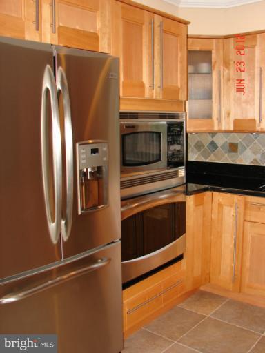 10414 Mountain Quail Road Silver Spring, MD 20901 - Photo 3 of 22 a kitchen with stainless steel appliances granite countertop a refrigerator and a sink
