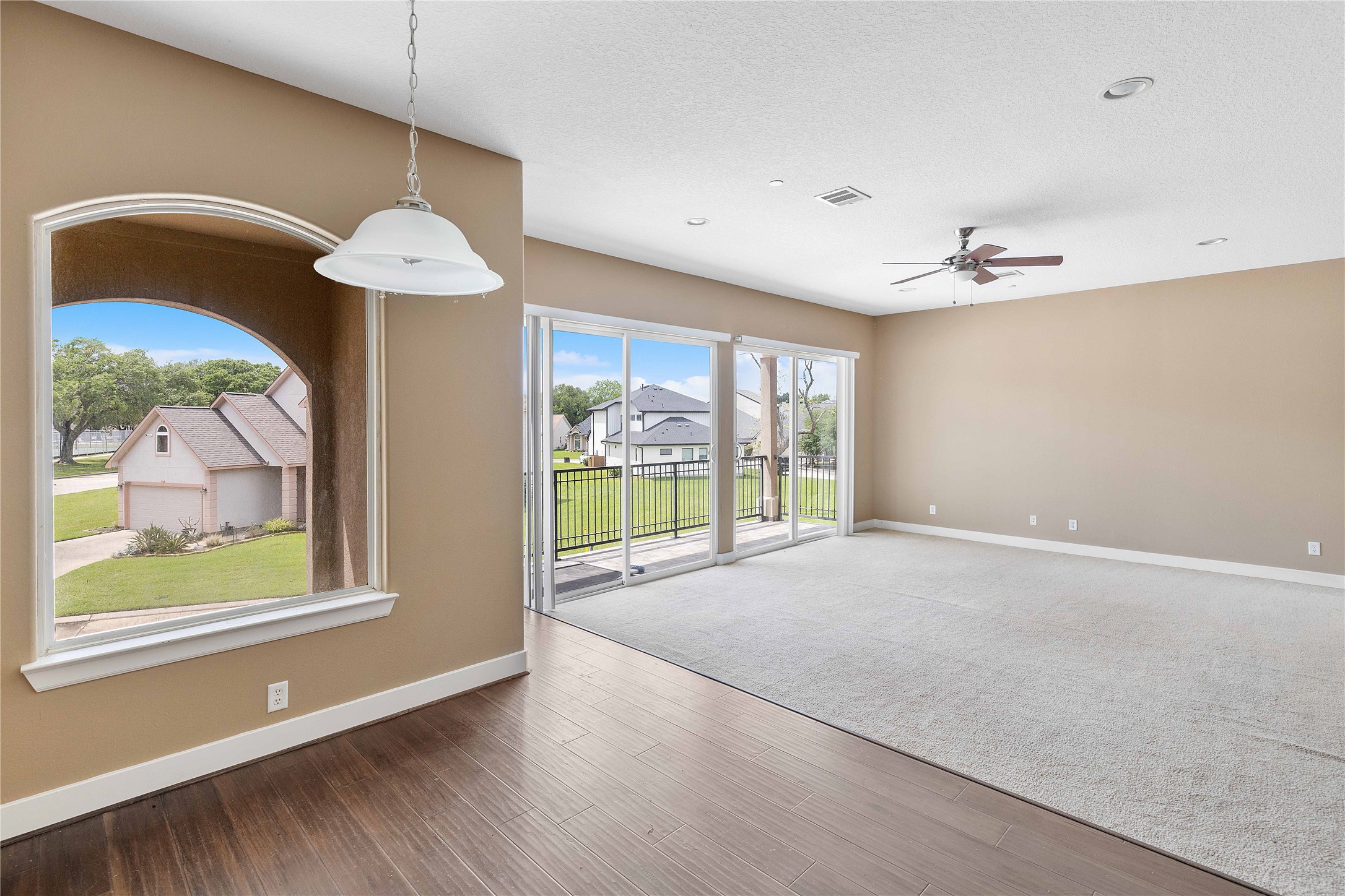 11446 Ketch Court Willis, TX 77318 - Photo 10 of 16 a view of an empty room with a window and wooden floor