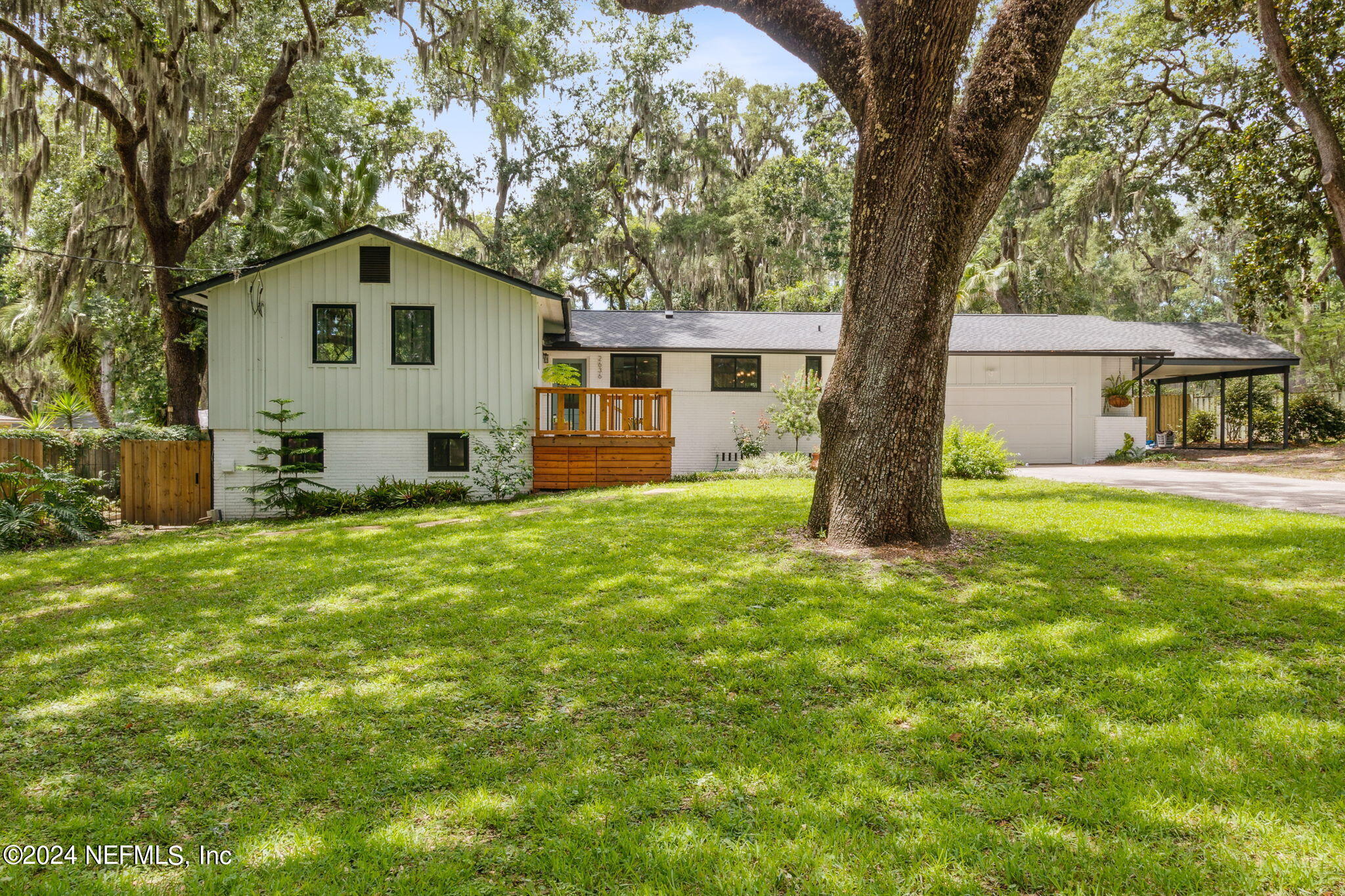 2636 Elbow Road Orange Park, FL 32073 - Photo 3 of 43 a view of a backyard with a large tree