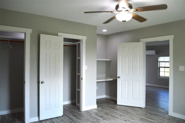 a view of a hallway with wooden floor and workspace