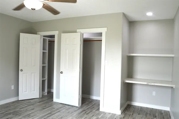 a view of an empty room with wooden floor