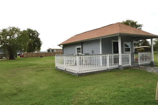 a view of a house with a yard and deck