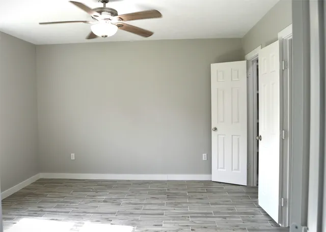 a view of an empty room with wooden floor