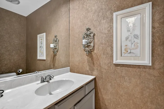 a bathroom with a sink vanity and a mirror