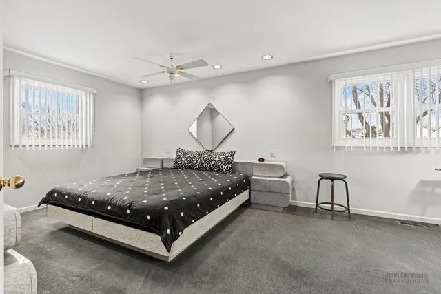 a bedroom with a bed couch and window