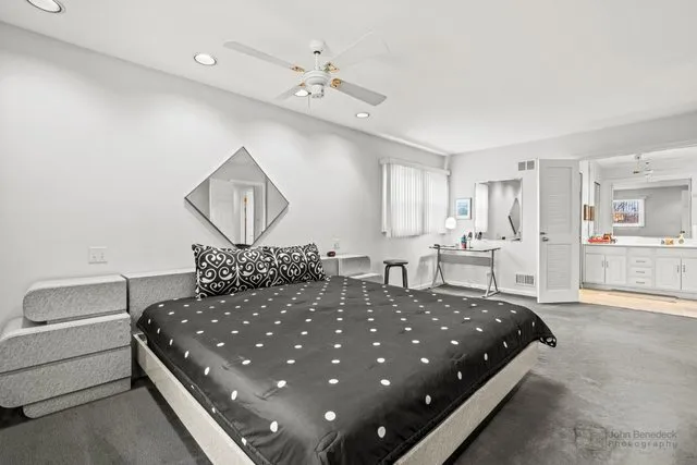 a large bedroom with a bed and a chandelier