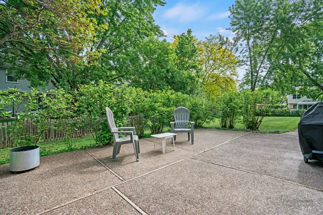 a view of a backyard with sitting area