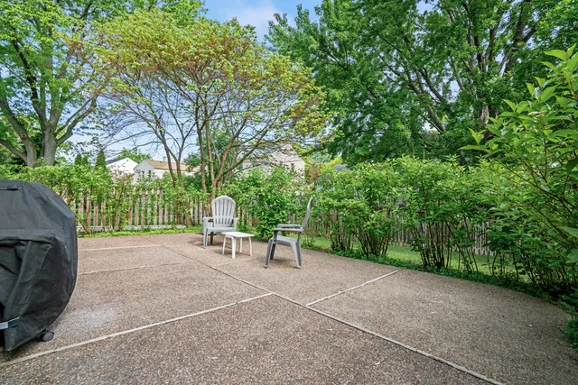 a view of a backyard with a table and chairs