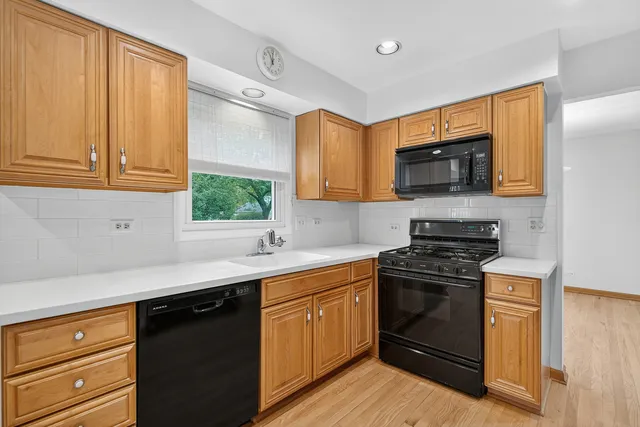 a kitchen with a sink stove and microwave