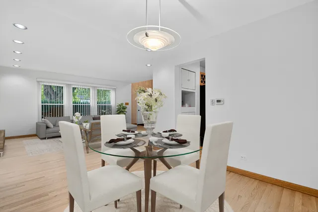 a dining room with furniture and wooden floor