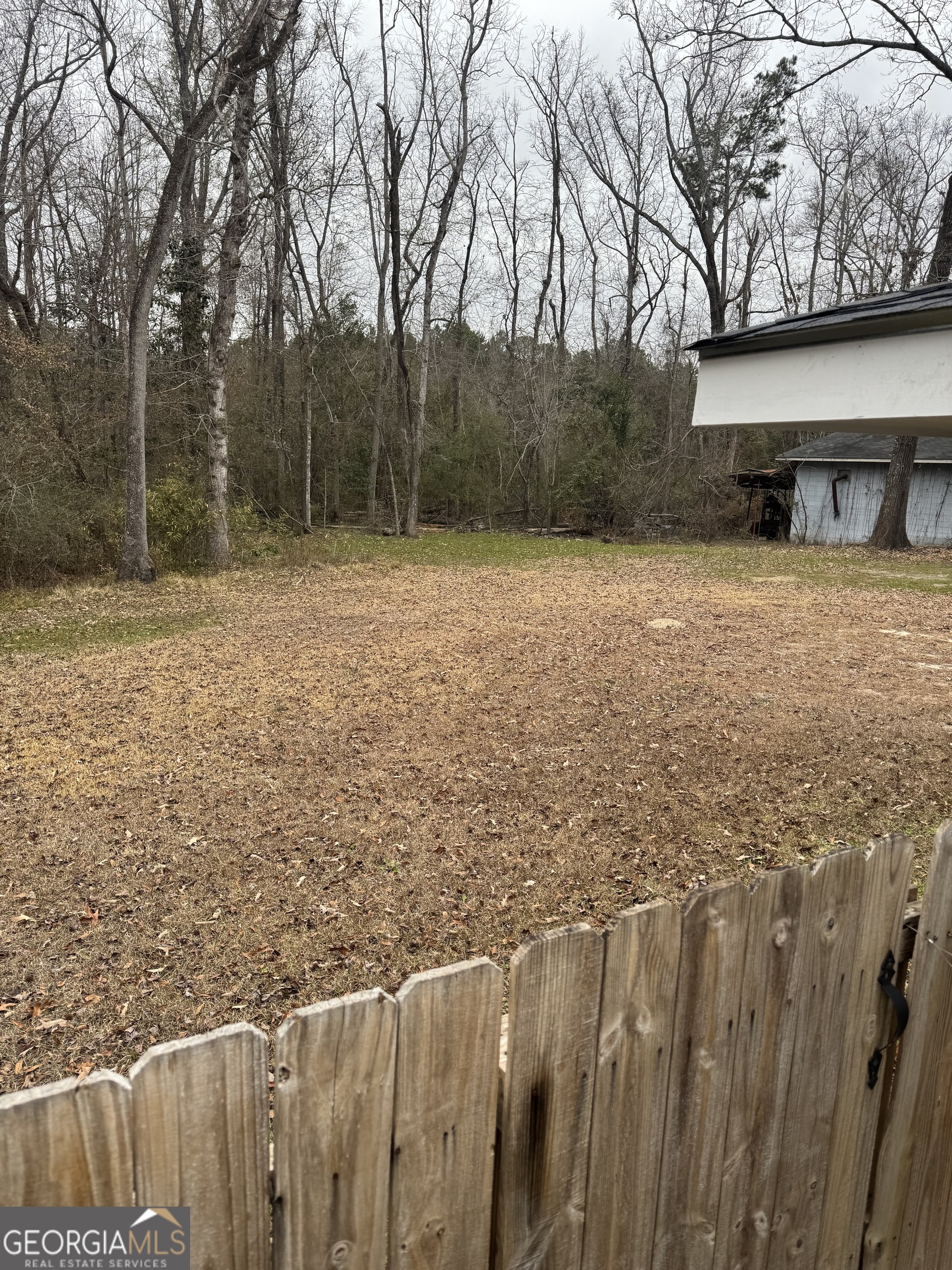 228 Hobbins Drive Dublin, GA 31021 - Photo 16 of 17 a view of a yard with wooden fence