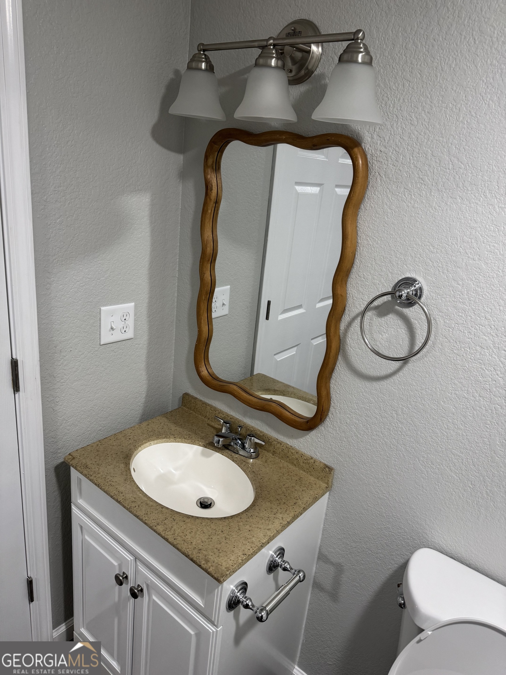 228 Hobbins Drive Dublin, GA 31021 - Photo 7 of 17 a bathroom with a sink and mirror with toilet