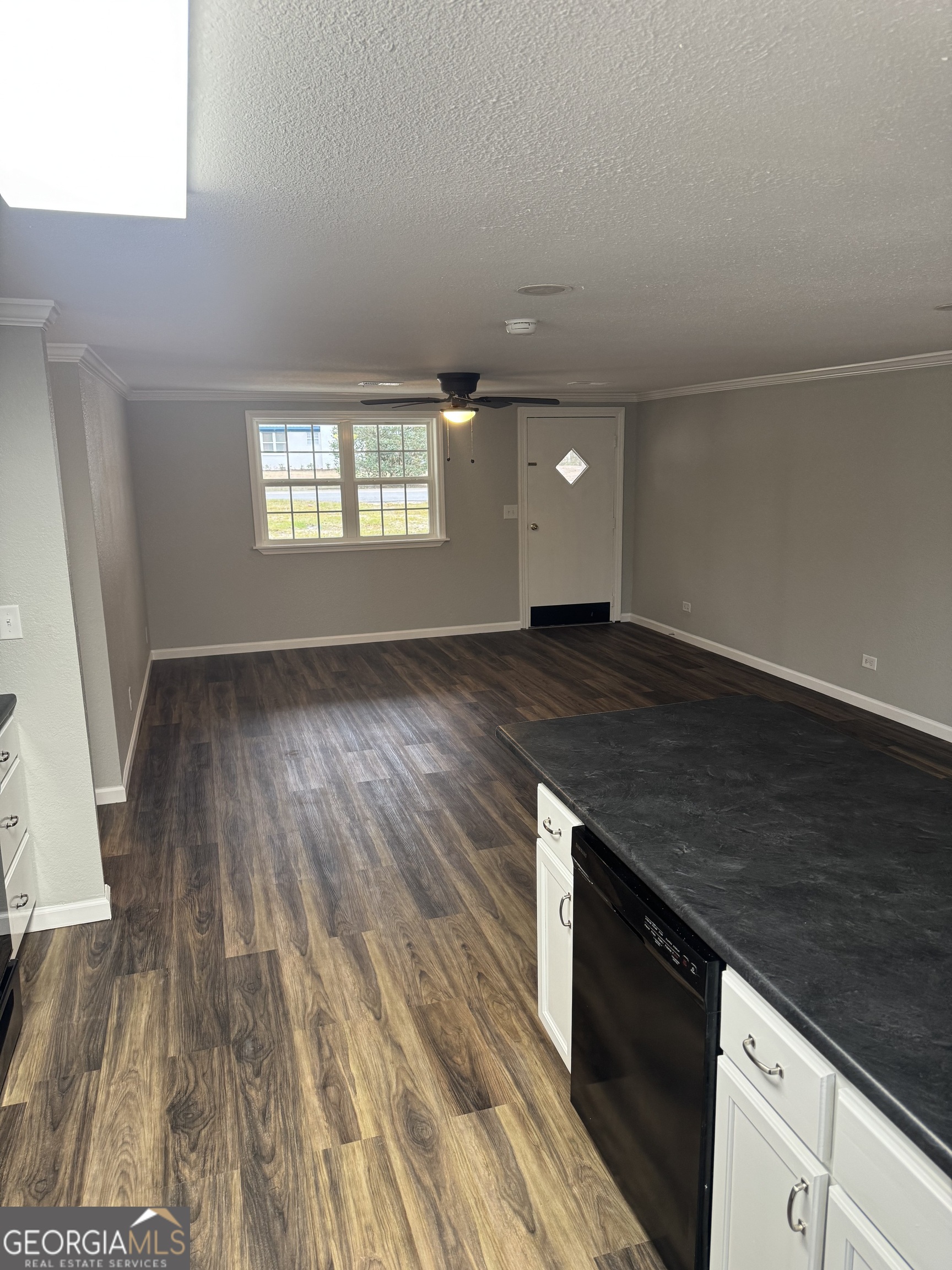 228 Hobbins Drive Dublin, GA 31021 - Photo 10 of 17 an empty room with wooden floor and windows