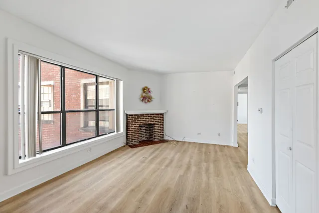 wooden floor in an empty room with a fireplace