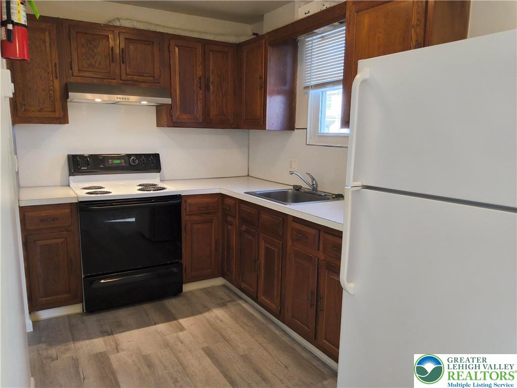 802 West Berwick Street Easton, PA 18042 - Photo 6 of 54 a kitchen with a sink a stove and cabinets