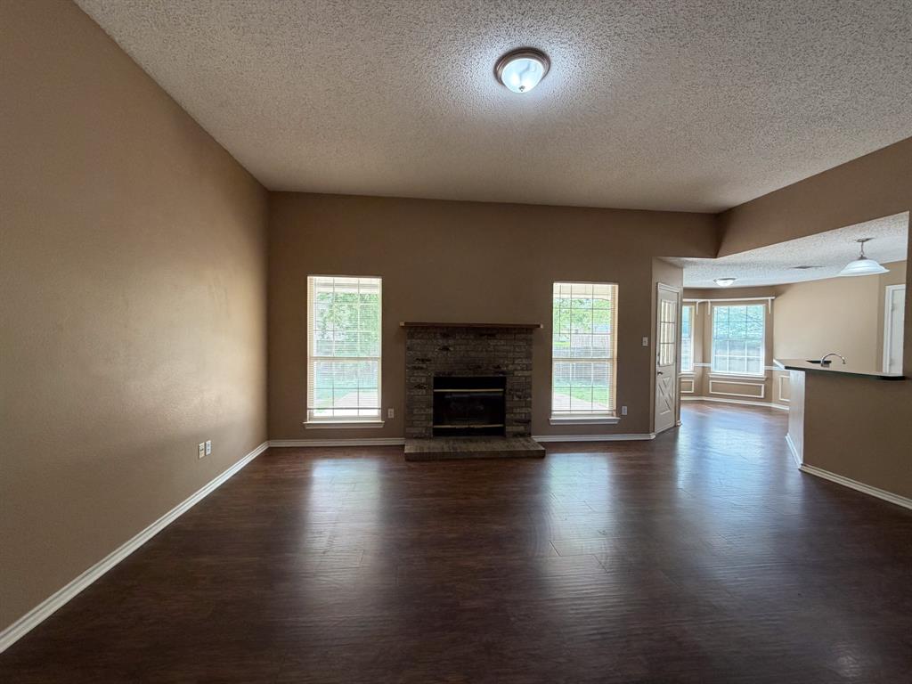 1000 Short Line Boulevard Midlothian, TX 76065 - Photo 4 of 23 an empty room with wooden floor fire place and windows