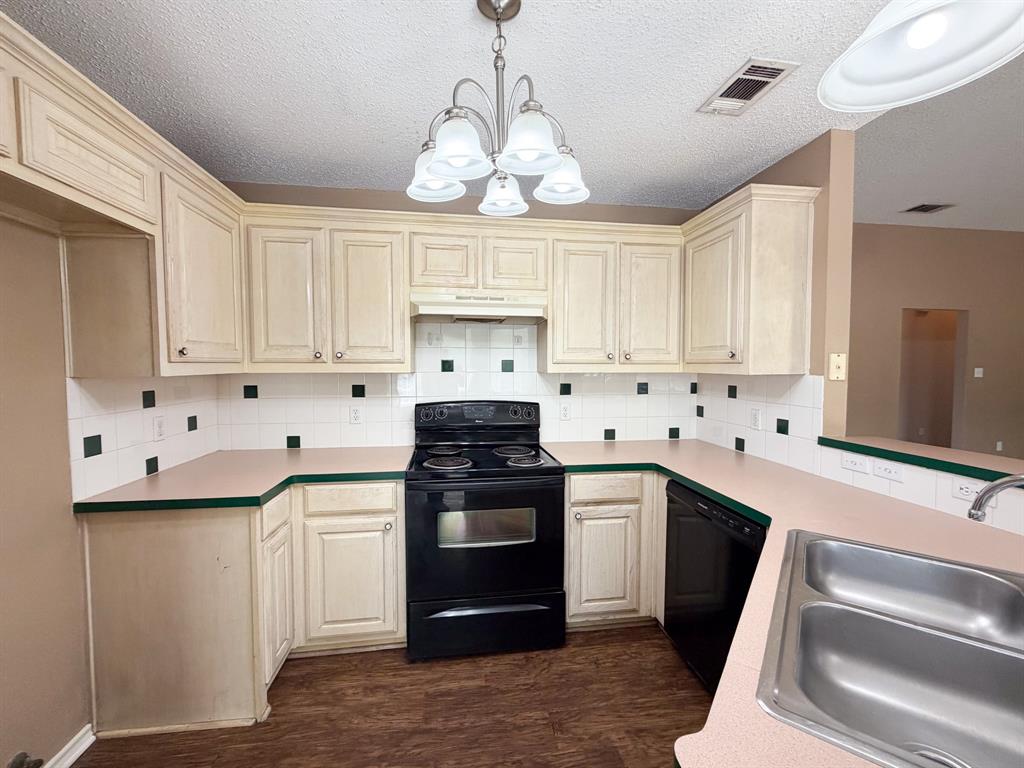 1000 Short Line Boulevard Midlothian, TX 76065 - Photo 9 of 23 a kitchen with granite countertop white cabinets white stainless steel appliances and sink