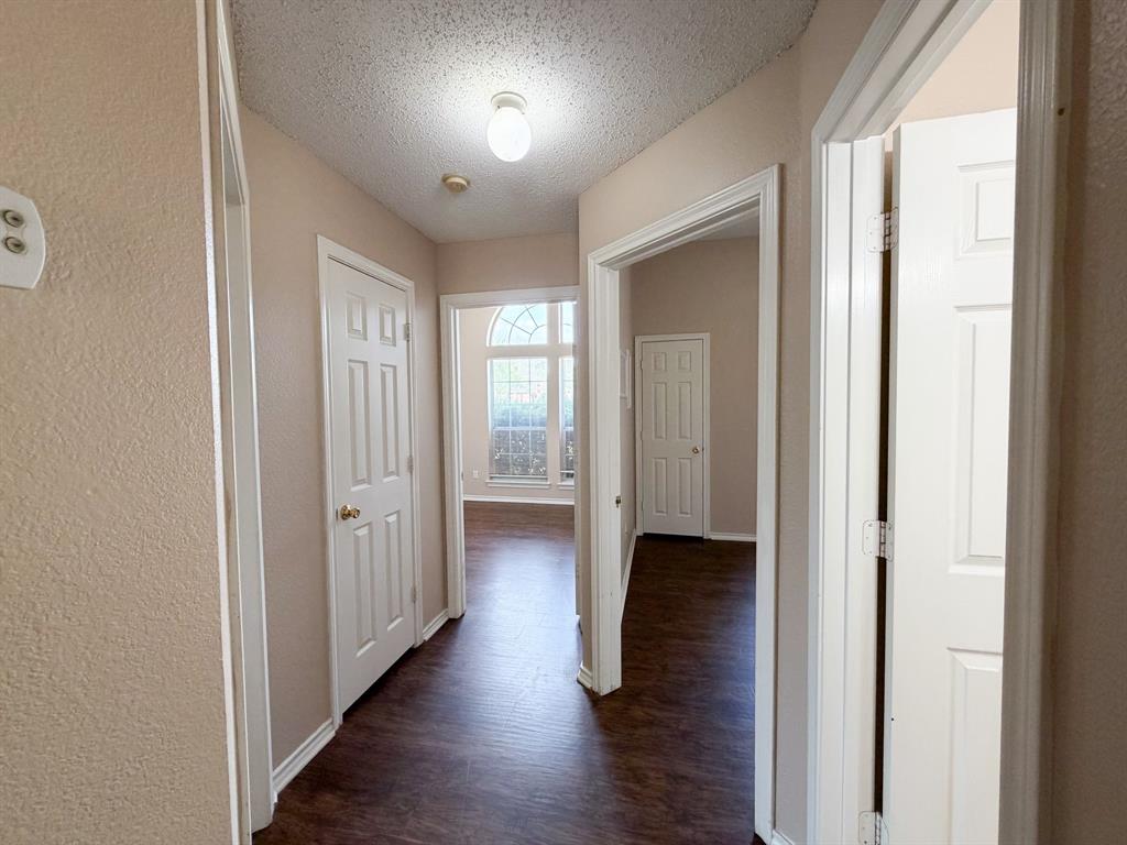 1000 Short Line Boulevard Midlothian, TX 76065 - Photo 10 of 23 a view of a hallway with wooden floor and a bathroom