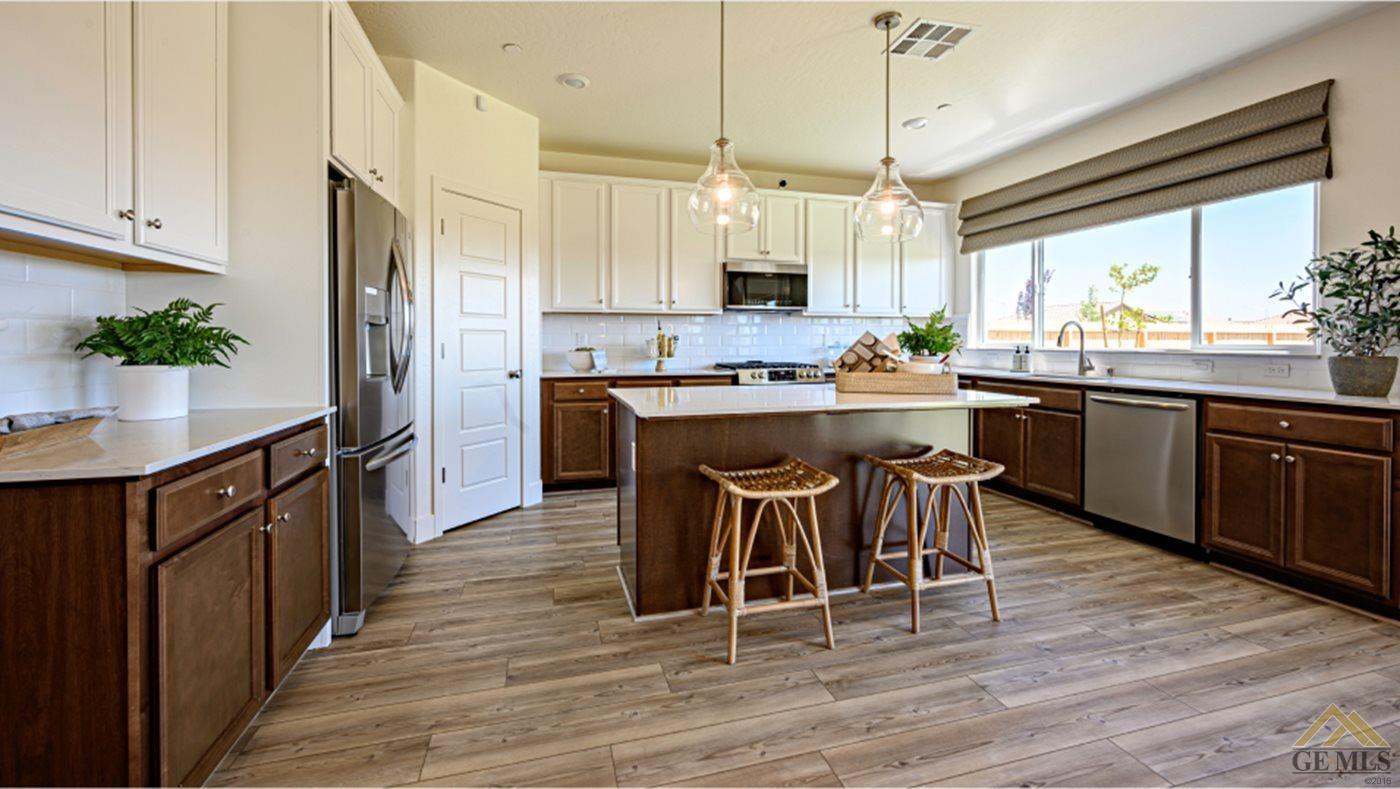 Undisclosed Address Bakersfield, CA 93313 - Photo 2 of 14 a kitchen with stainless steel appliances a dining table chairs and wooden floor