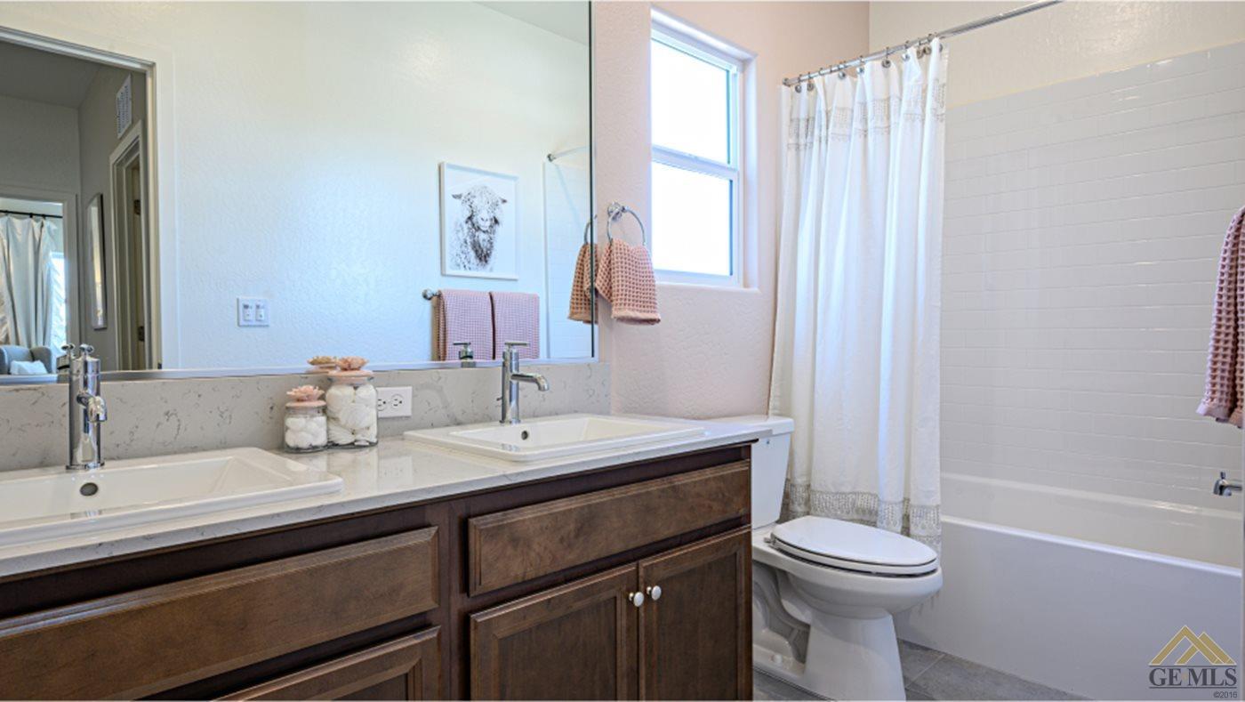 Undisclosed Address Bakersfield, CA 93313 - Photo 4 of 14 a bathroom with a sink a toilet and shower
