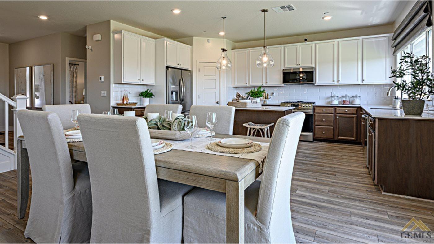Undisclosed Address Bakersfield, CA 93313 - Photo 5 of 14 a kitchen with stainless steel appliances granite countertop a stove a sink a microwave a refrigerator white cabinets and wooden floor