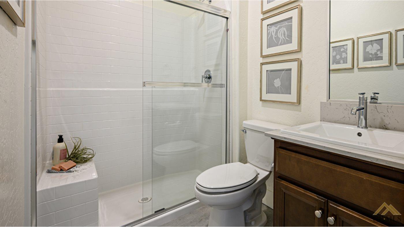 Undisclosed Address Bakersfield, CA 93313 - Photo 9 of 14 a bathroom with a sink a toilet and shower