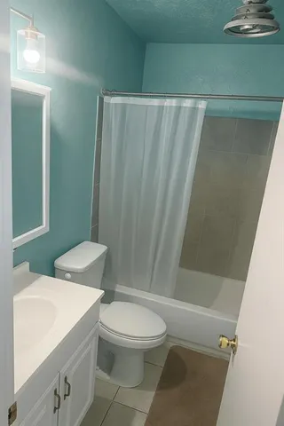 a white toilet sitting next to a bathroom sink