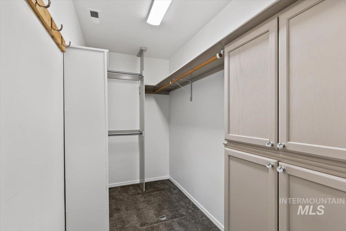 12781 Ashfield Street Caldwell, ID 83607 - Photo 24 of 36 Walk in closet featuring dark carpet